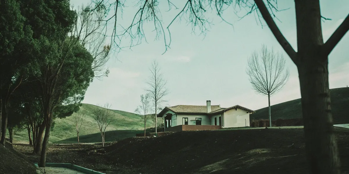 Getting an insurance quote for a house in a high fire risk area surrounded by trees and hills.