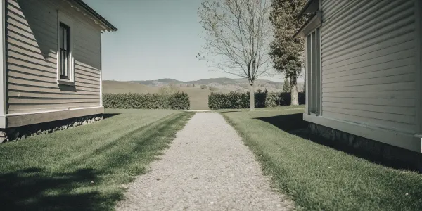 How to create defensible space using a gravel path and a well-maintained lawn next to a house.