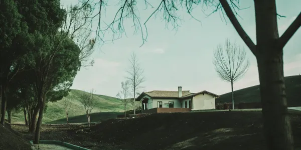 Getting an insurance quote for a house in a high fire risk area surrounded by trees and hills.