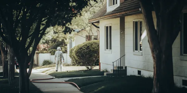 Home inspector checking a house's exterior to pass a home insurance fire inspection.