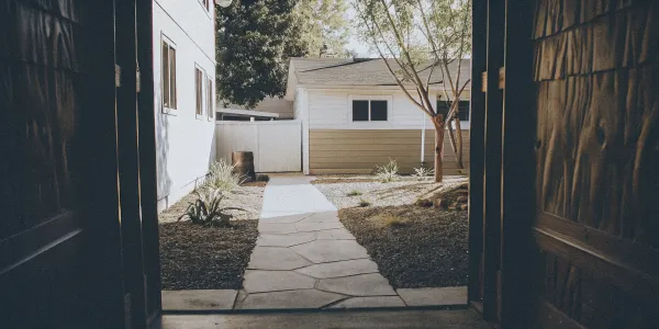 Zone 0 defensible space: Hardscaping, fire-resistant plants, and clear area around a house.