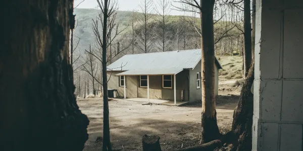 A home hardened against wildfires with a metal roof and a clear defensible space around it.