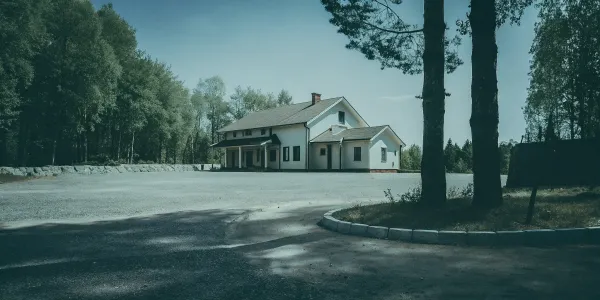 A home surrounded by trees in a high-risk fire area needs the best insurance.